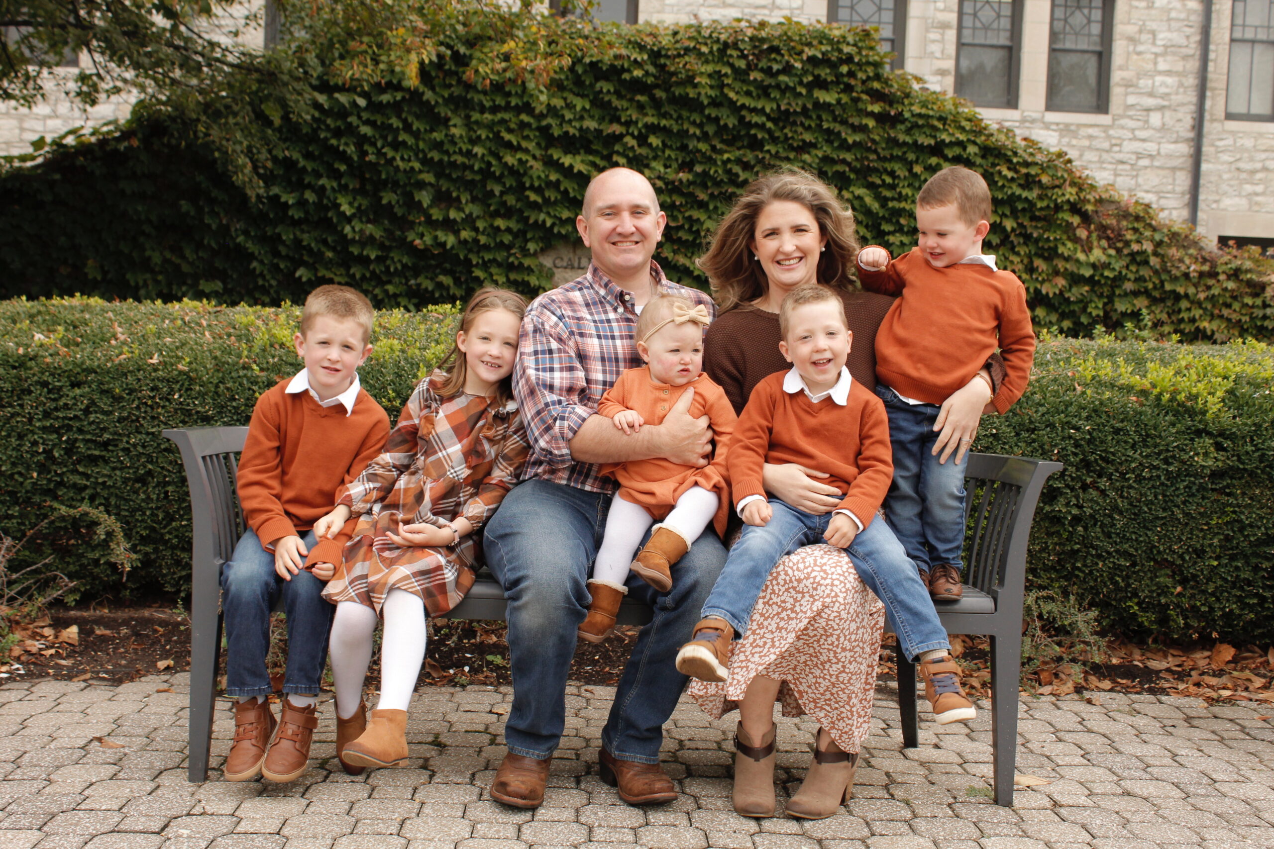 family of seven on park bench